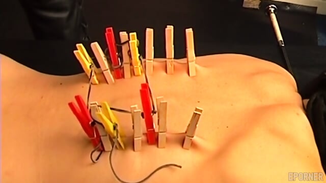 Blonde Woman Endures Painful Clothespins On Her Back