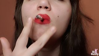Natural big lips with red lipstick smoking