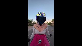 sexy biker girl does wet t-shirt contest on her bike while riding
