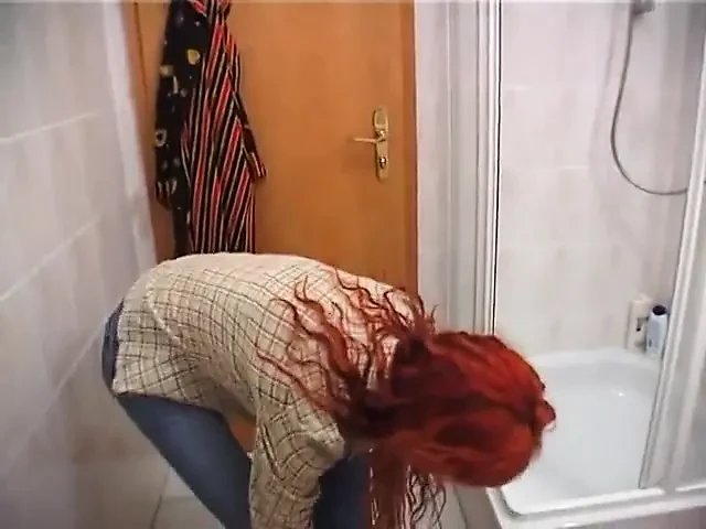 Redhead beauty showering solo